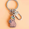 Charming wooden keyring of a capybara with a small bird perched on its head, finely engraved with natural details.