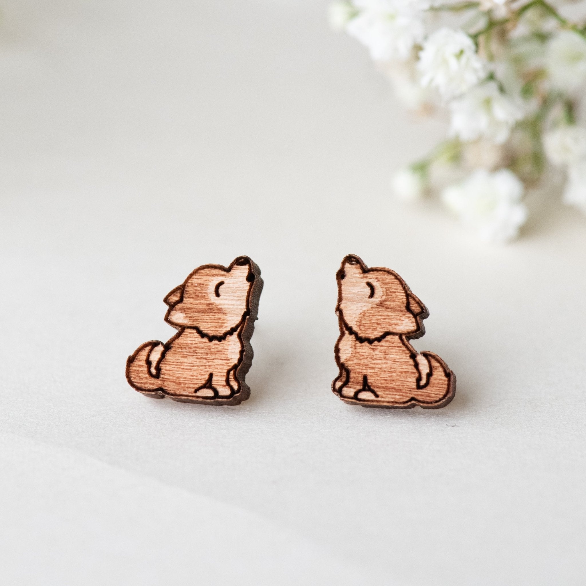 a pair of howling baby wolf earrings, handmade with solid woode and  Hypoallergenic stainless steel